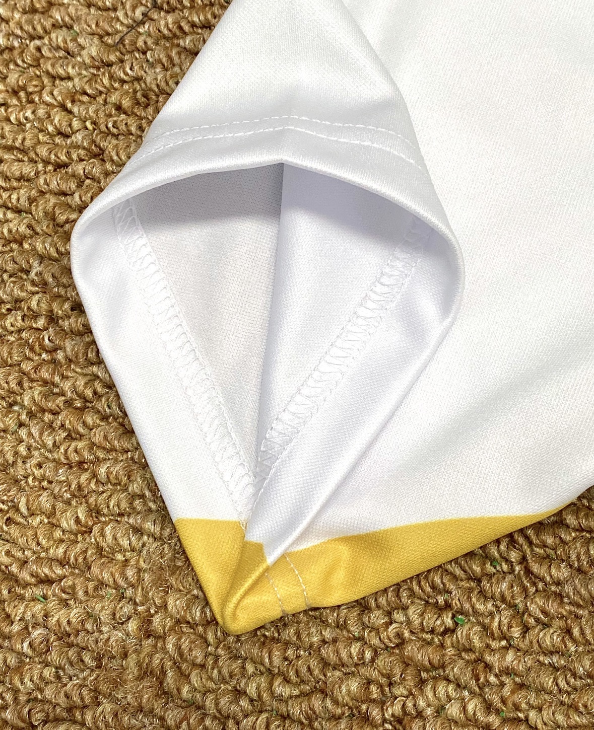 Close-up of custom sleeve trim and garment stitching